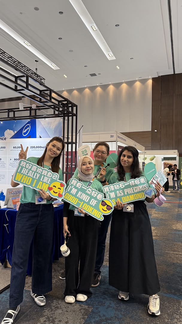 Visitors learning about digital health consult benefits at the IOI Career Fair booth